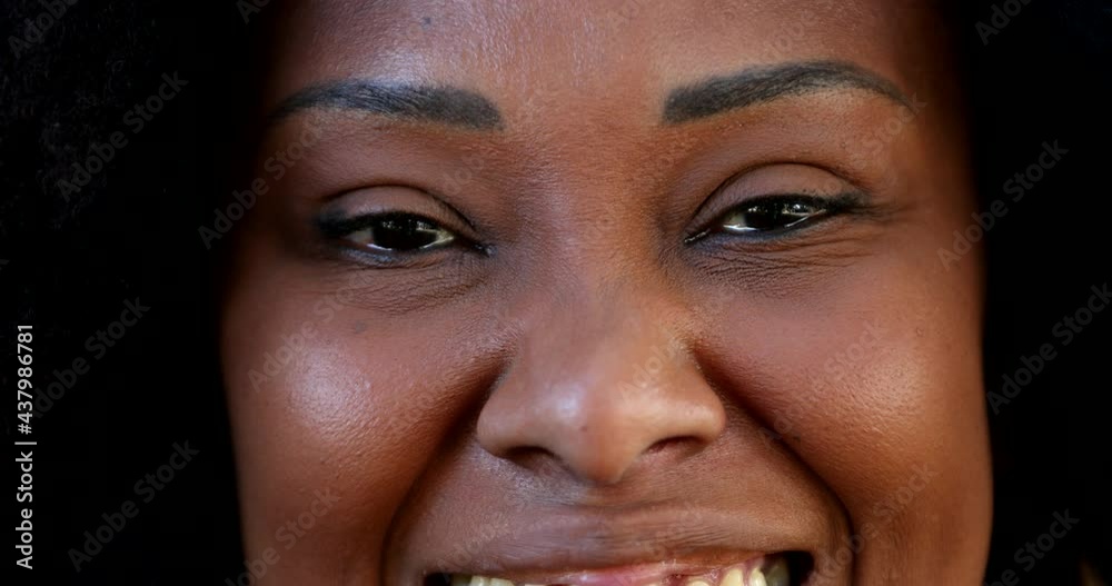 Positive African woman opening eyes smiling at camera, macro close-up eye smile Positive African woman opening eyes smiling at camera, macro close-up eye smile