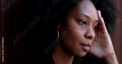 Preoccupied African woman, anxious suffering person photo