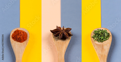 Foto Set of spices on wooden spoons and colorful backgrounds.