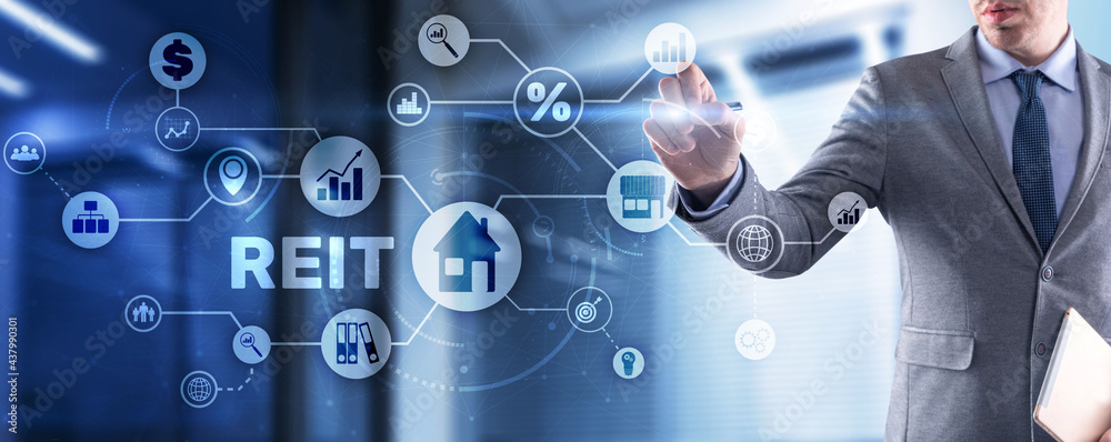 REIT. Real estate investment trust. Financial Market. Hand pressing button on screen REIT. Real estate investment trust. Financial Market. Hand pressing button on screen