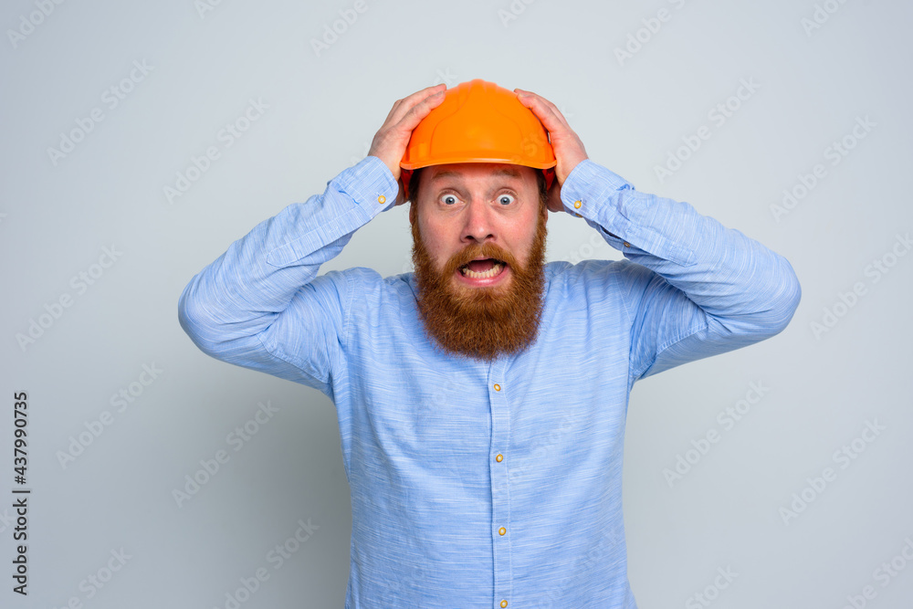 Isolated amazed architect with beard and orange helmet Isolated amazed architect with beard and orange helmet
