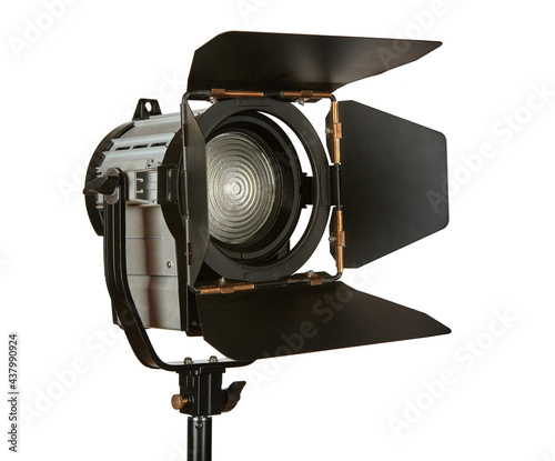 Constant light illuminator with curtains and fresnel lens on a stand for filming movies. The device is isolated on a white background. photo