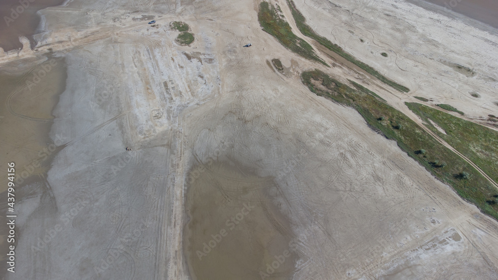The bottom of a dried up salt lake. View from the air. Traces of cars and motorcycles in the sand.