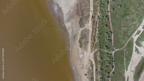 The bottom of a dried up salt lake. View from the air. Traces of cars and motorcycles in the sand.
