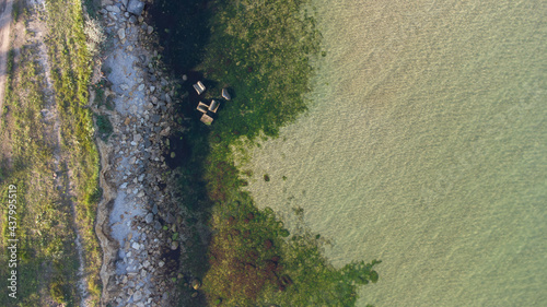 Wallpaper Mural Aerial view of the stony seashore. Transparent water and stones in the water. Torontodigital.ca