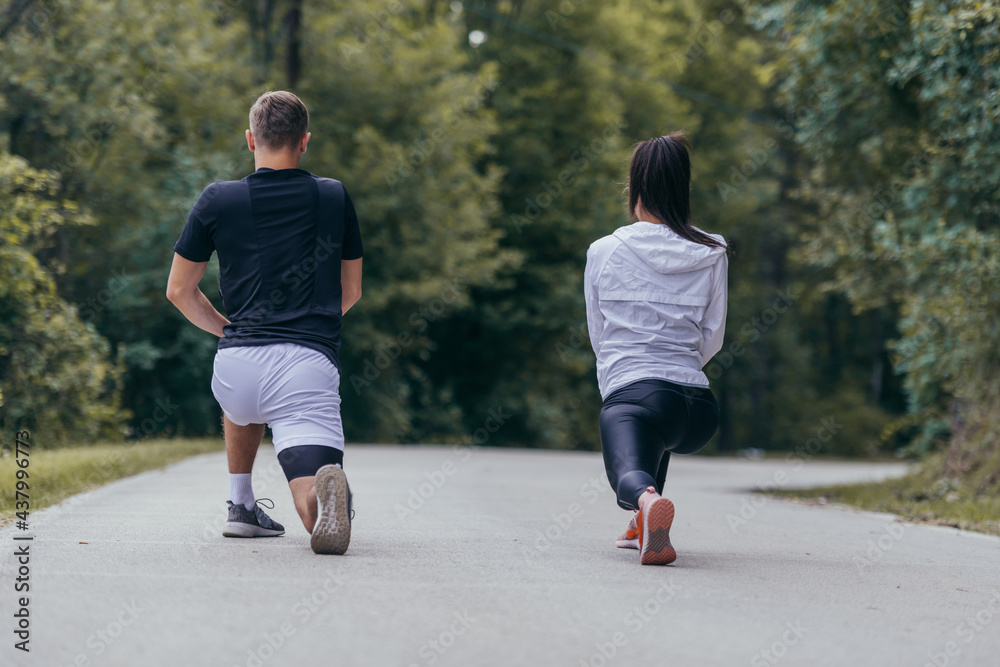 Obraz premium Male and female athletes preparing for a marathon, run, workout. Healthy lifestyle concept.