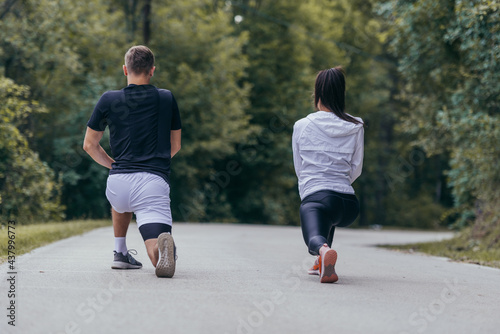 Male and female athletes preparing for a marathon, run, workout. Healthy lifestyle concept.
