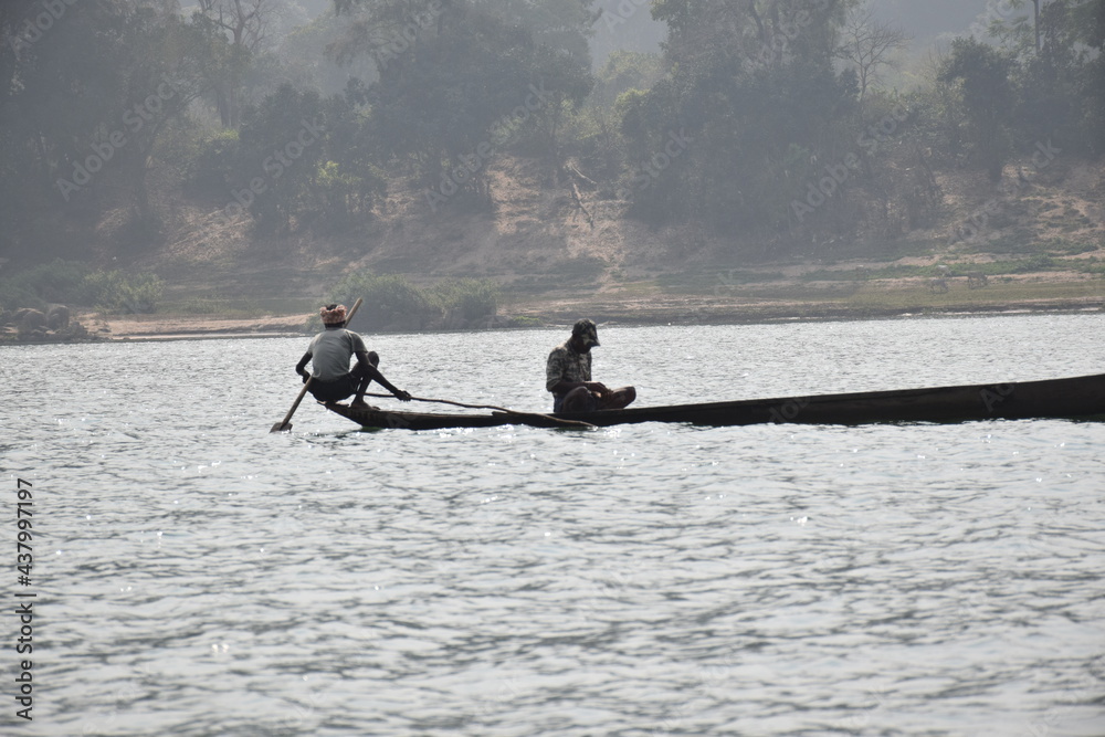 Satkosia, Odisha, India- 25 January 2021. Two Men on a Boat fishing on river
