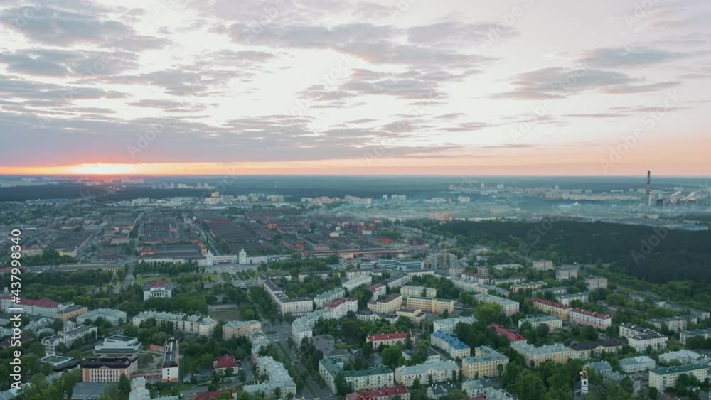 Aerial time lapse hyperlapse sunrise over big city, morning cityscape. Drone flight over industrial landscape. Bright sun in clouds on horizon. Belarus, Minsk at dawn overlooking city skyline Aerial time lapse hyperlapse sunrise over big city, morning cityscape. Drone flight over industrial landscape. Bright sun in clouds on horizon. Belarus, Minsk at dawn overlooking city skyline