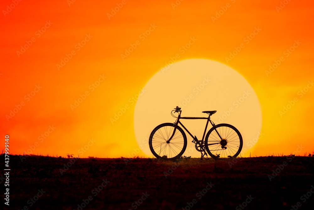 Silhouette of a bicycle with big sun
