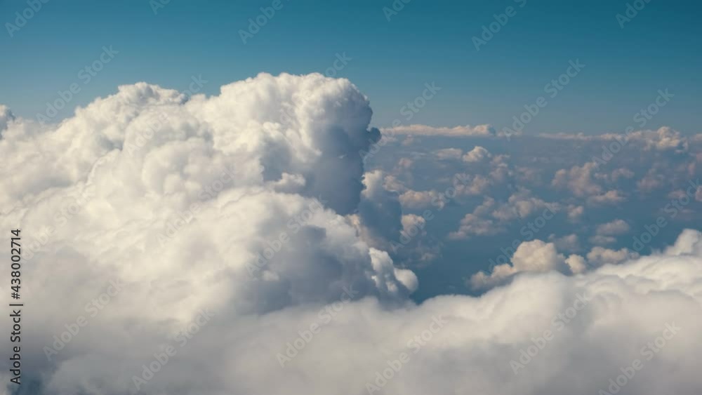 Aerial view from airplane window of white puffy clouds on bright sunny day. Aerial view from airplane window of white puffy clouds on bright sunny day.