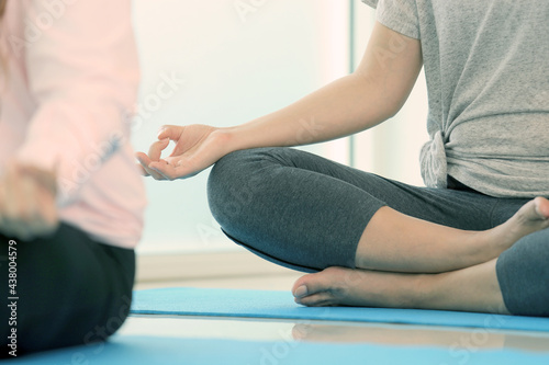 Group of meditation of students and teacher practicing relaxation of mind at yoga studio. Tranquility by calm position is the way of zen and buddhism.