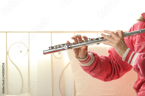 Flute classical instrument player playing song. Instructor Flutist practicing bronze woodwind for orchestra as solo at home.