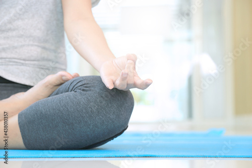 Group of meditation of students and teacher practicing relaxation of mind at yoga studio. Tranquility by calm position is the way of zen and buddhism. photo