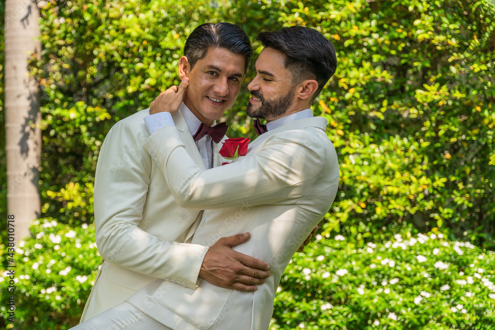 LGBTQ gay couple happy dancing together in wedding ceremony LGBTQ gay couple happy dancing together in wedding ceremony