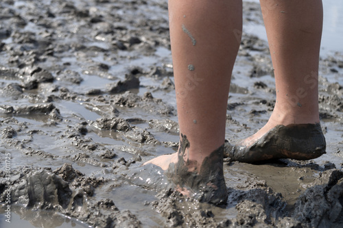Girl bare foot on mudflat © Awesomelia