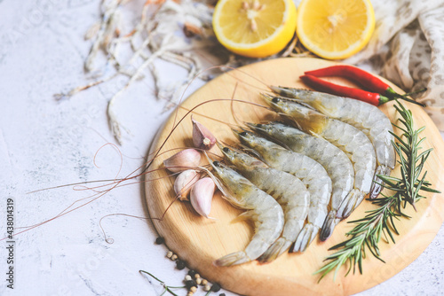 Fresh shrimp seafood with herbs and spice ready for cooked food, Raw shrimps prawns on wooden plate