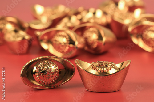 Golden chinese traditional money on red color background. Representing rich, wellness, properity, lucky, happiness for Chinese New Year celebration