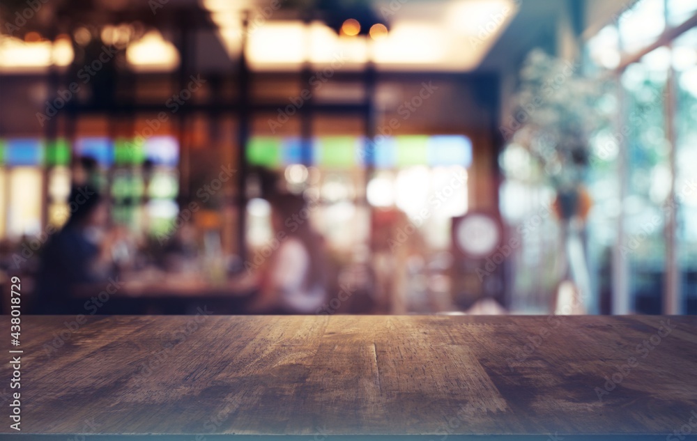 Empty wooden table in front of abstract blurred background of coffee shop . can be used for display or montage your products.Mock up for display of product. - obrazy, fototapety, plakaty 