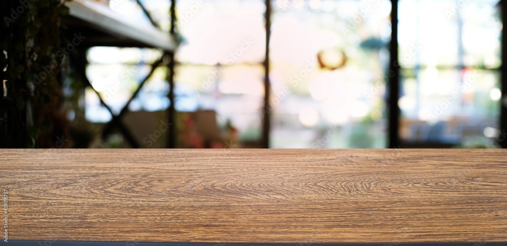 Empty dark wooden table in front of abstract blurred bokeh background of restaurant . can be used for display or montage your products.Mock up for space. Empty dark wooden table in front of abstract blurred bokeh background of restaurant . can be used for display or montage your products.Mock up for space.