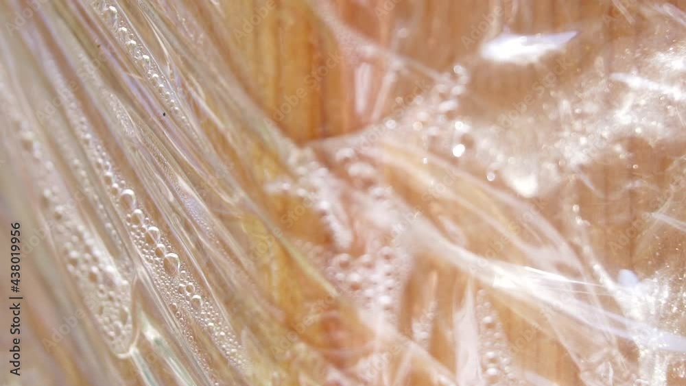 Stretch film texture on wood. 4K Macro detail. Stretch film texture on wood. 4K Macro detail.