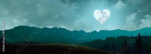 Fotografie beautiful landscape in the mountains with the moon in the shape of a heart