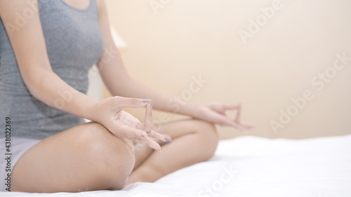 Yoga meditation on bed. Mudras is a type of finger position to make peace and mind to Chakr. © soultkd