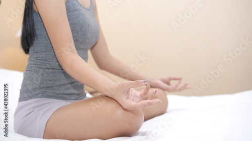 Yoga meditation on bed. Mudras is a type of finger position to make peace and mind to Chakr.