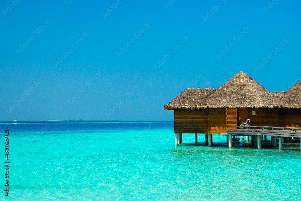 Maldives paradise scenic landscape. Seascape with water bungalows, turquoise sea and lagoon waters, tropical nature. Exotic tropical island beach background. Romantic holiday & honeymoon destination. Maldives paradise scenic landscape. Seascape with water bungalows, turquoise sea and lagoon waters, tropical nature. Exotic tropical island beach background. Romantic holiday & honeymoon destination.