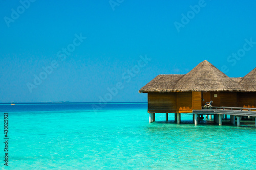 Maldives paradise scenic landscape. Seascape with water bungalows, turquoise sea and lagoon waters, tropical nature. Exotic tropical island beach background. Romantic holiday & honeymoon destination.