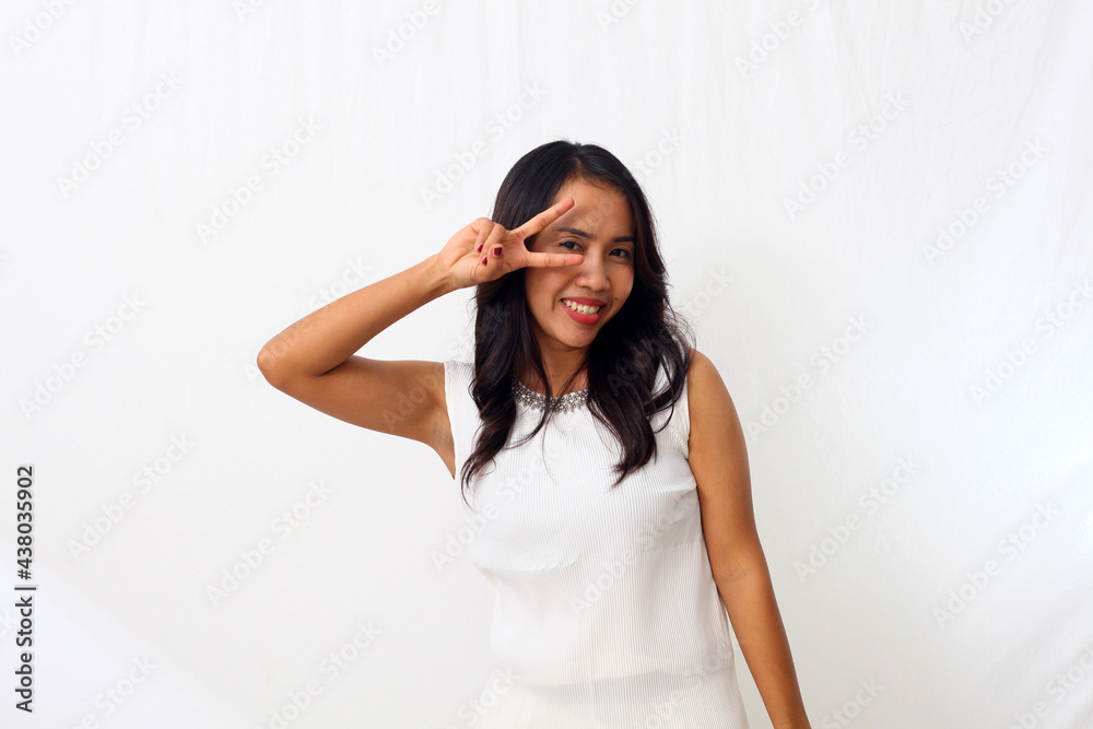 Young asian woman doing peace symbol with fingers over face, smiling cheerful showing victory Young asian woman doing peace symbol with fingers over face, smiling cheerful showing victory