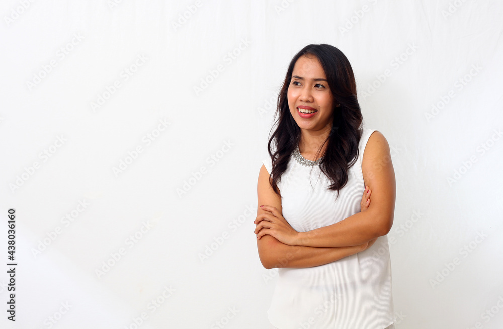 The beautiful young Asian girl smiled as she folded her arms and looking at blank space. Isolated on white background The beautiful young Asian girl smiled as she folded her arms and looking at blank space. Isolated on white background