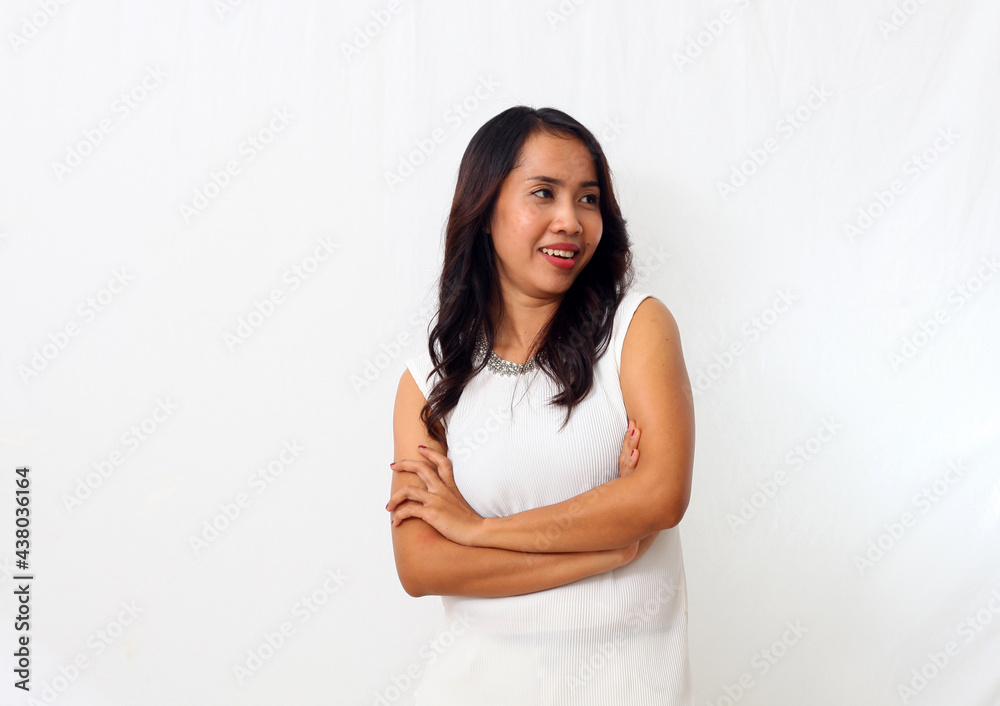 The beautiful young Asian girl smiled as she folded her arms and looking at blank space. Isolated on white background The beautiful young Asian girl smiled as she folded her arms and looking at blank space. Isolated on white background