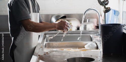 Man washing dish photo