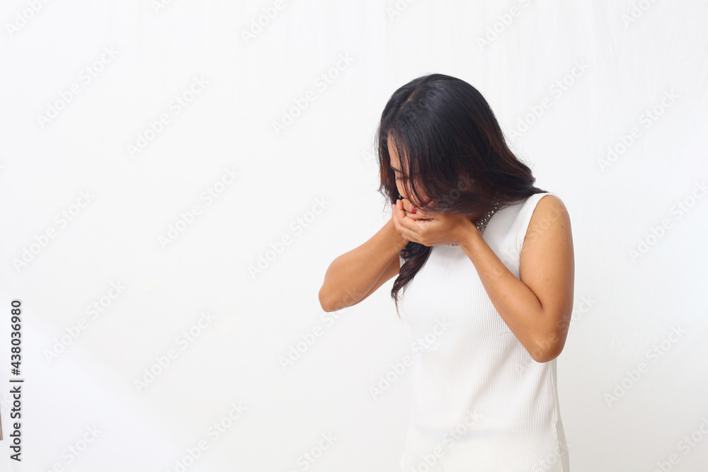 Beautiful asian girl standing holding her stomach and feeling nauseous and going to vomit. Isolated on white background with copyspace Beautiful asian girl standing holding her stomach and feeling nauseous and going to vomit. Isolated on white background with copyspace