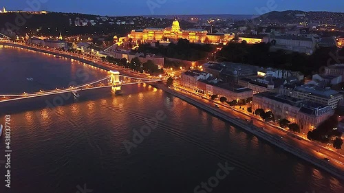 Cinematic 4K aerial drone night dolly footage of Castle Hill, Buda Castle, Gellért Hill and the Citadella fortress with the Danube river, bridges illuminated after sunset in Budapest, Hungary