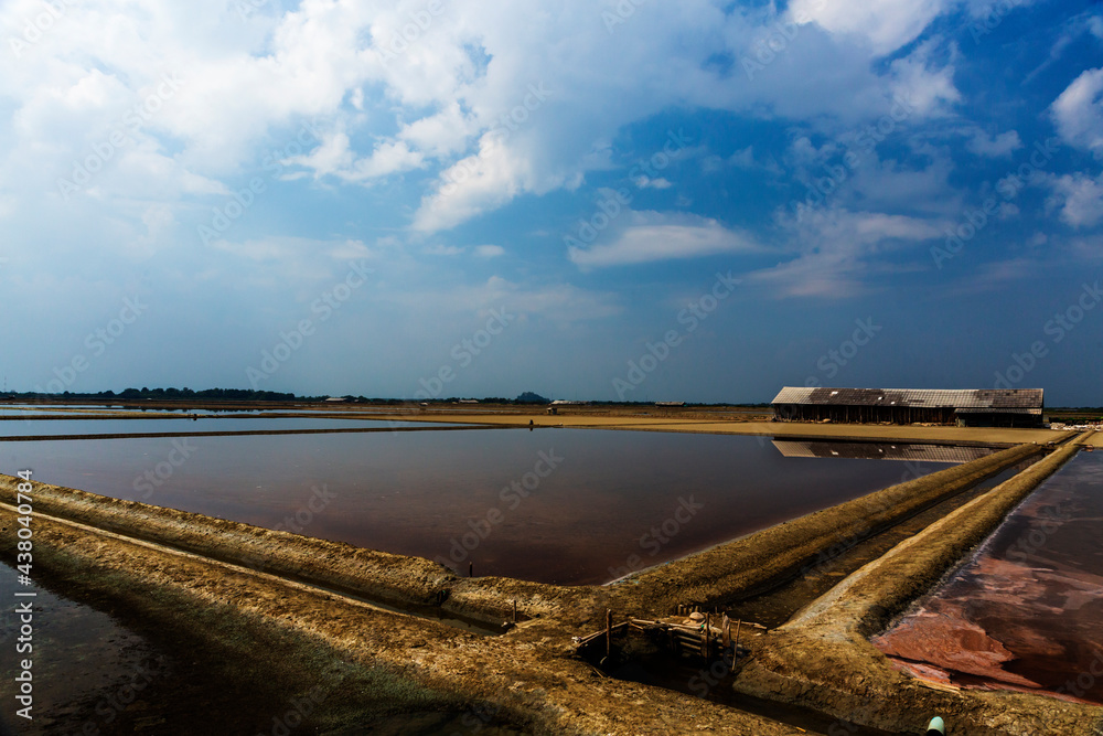 Sea salt farm and barn in Thailand. Organic sea salt. Raw material of salt industrial. Sodium Chloride. Solar evaporation system. Iodine source.