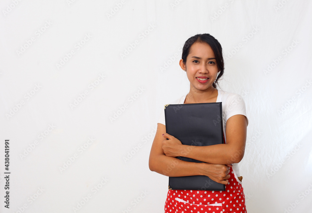 Portrait of asian woman wearing kitchen apron while holding a food menu. Isolated on white background Portrait of asian woman wearing kitchen apron while holding a food menu. Isolated on white background