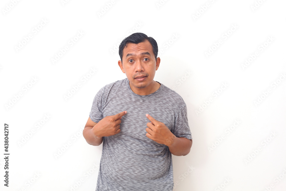Angry, mad, unhappy young guy pointing at himself you mean me, you talking to me, Isolated on white background. Negative human emotion facial expression feeling - obrazy, fototapety, plakaty 