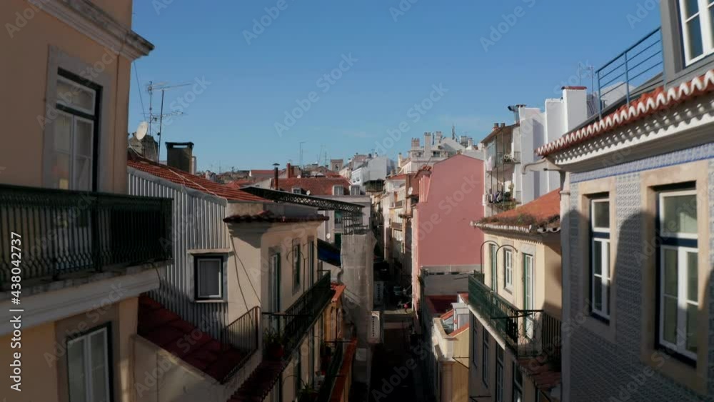 Descending aerial street view of narrow streets with colorful traditional Portuguese houses in Lisbon city center Descending aerial street view of narrow streets with colorful traditional Portuguese houses in Lisbon city center