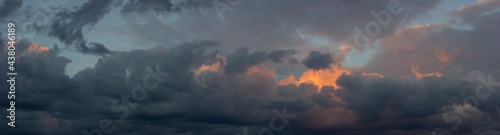 Photography Dark sky with orange clouds illuminated by the sun at sunset
