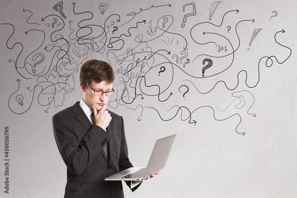 Thoughtful businessman with abstract arrows sketch on concrete wall background. Confusion and direction concept. Thoughtful businessman with abstract arrows sketch on concrete wall background. Confusion and direction concept.