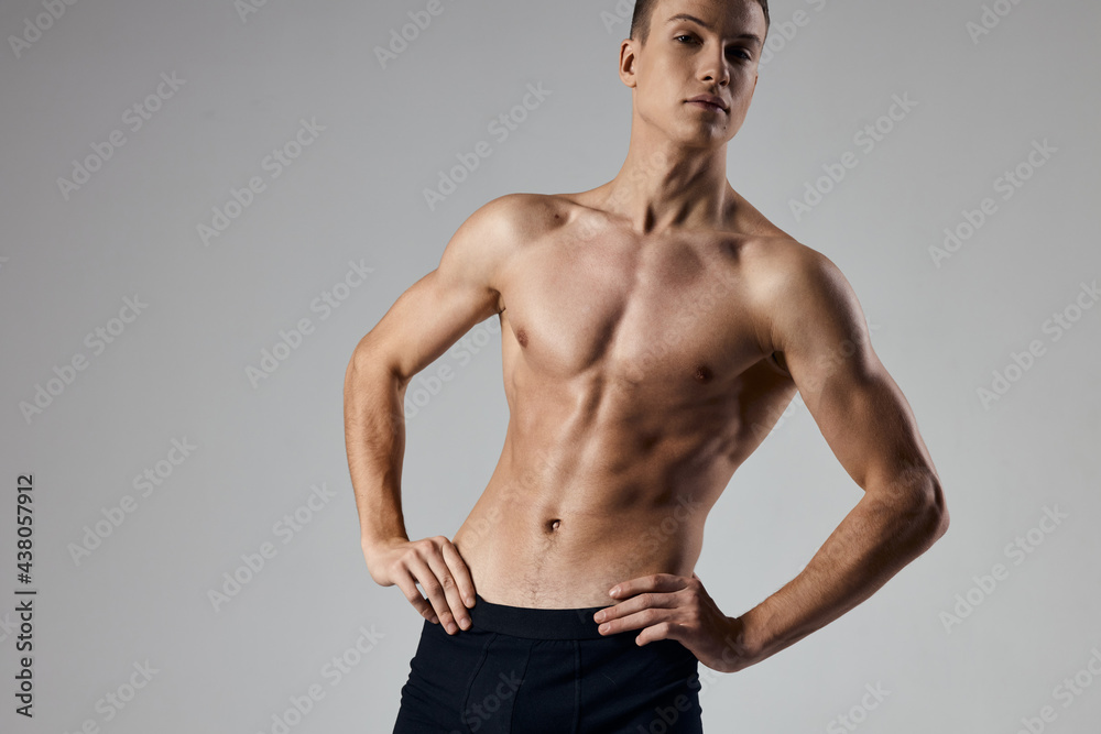 sporty man holding hands on belt on gray background cropped view model sporty man holding hands on belt on gray background cropped view model
