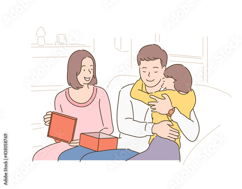 A young daughter is giving a present to her father and mother and a father is hugging her daughter. hand drawn style vector design illustrations. 