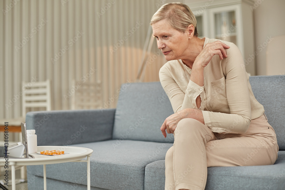 Telemedicine concept. Old woman with tablet during an online consultation with her doctor in her living room Telemedicine concept. Old woman with tablet during an online consultation with her doctor in her living room