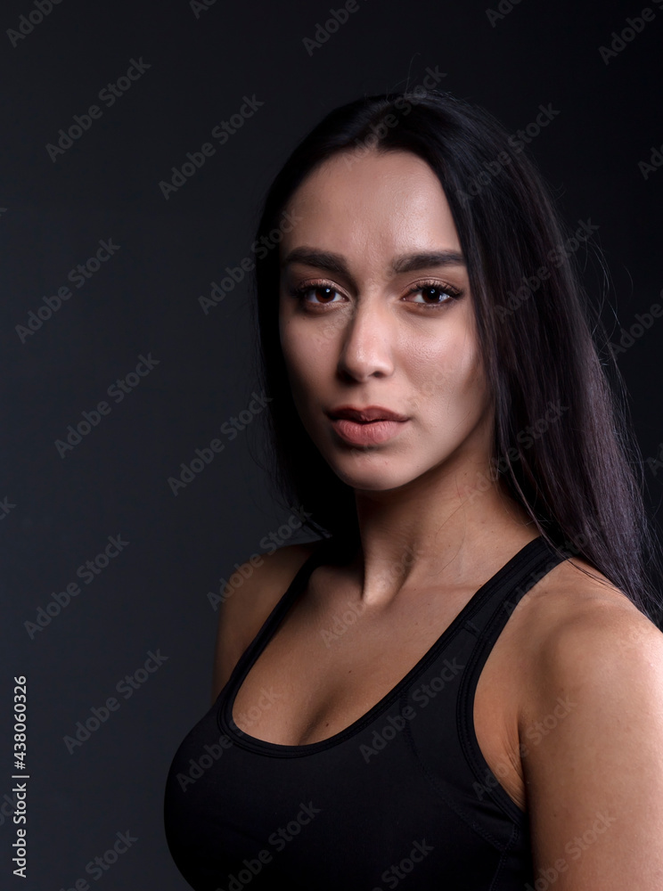 portrait of a young woman in the studio on a dark background portrait of a young woman in the studio on a dark background