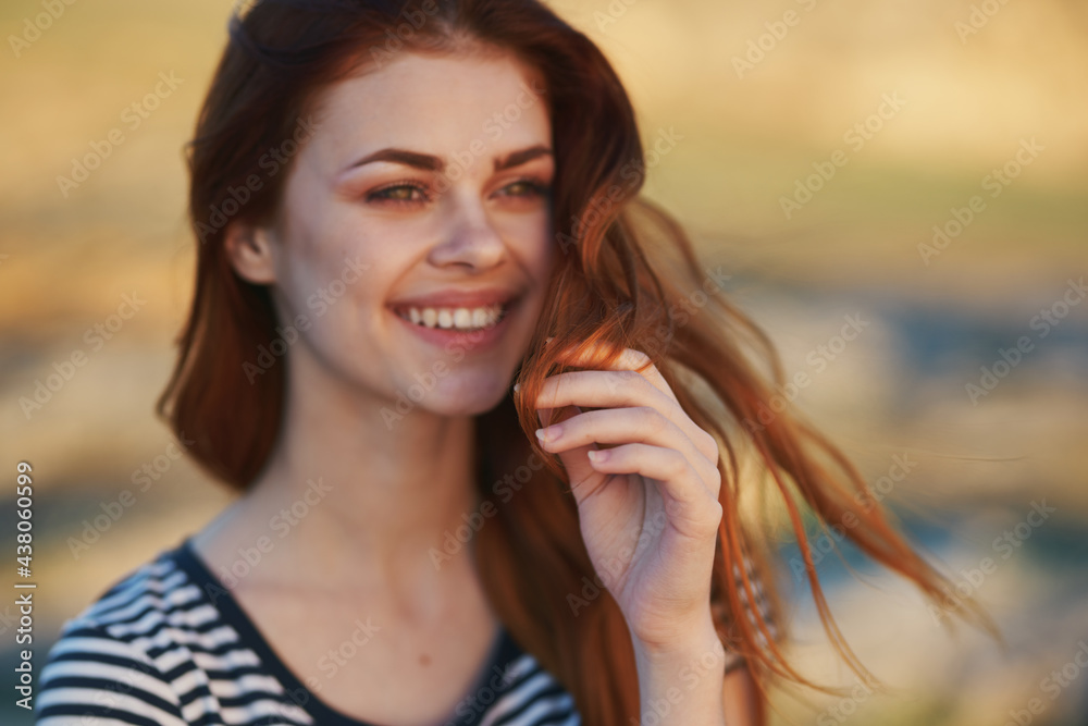romantic woman in the mountains outdoors in a striped t-shirt fresh air sea mountains