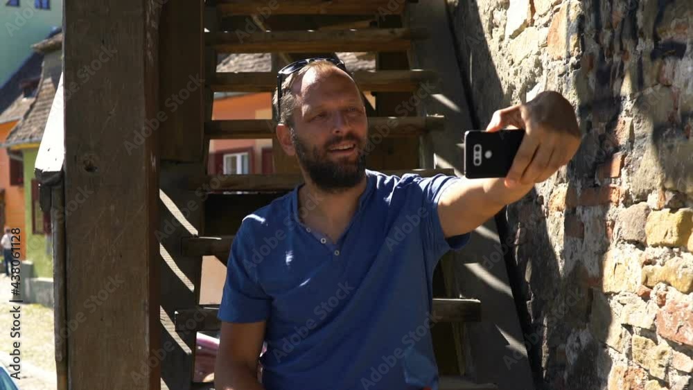 Young man taking selfie photo with smartphone in the city Young man taking selfie photo with smartphone in the city