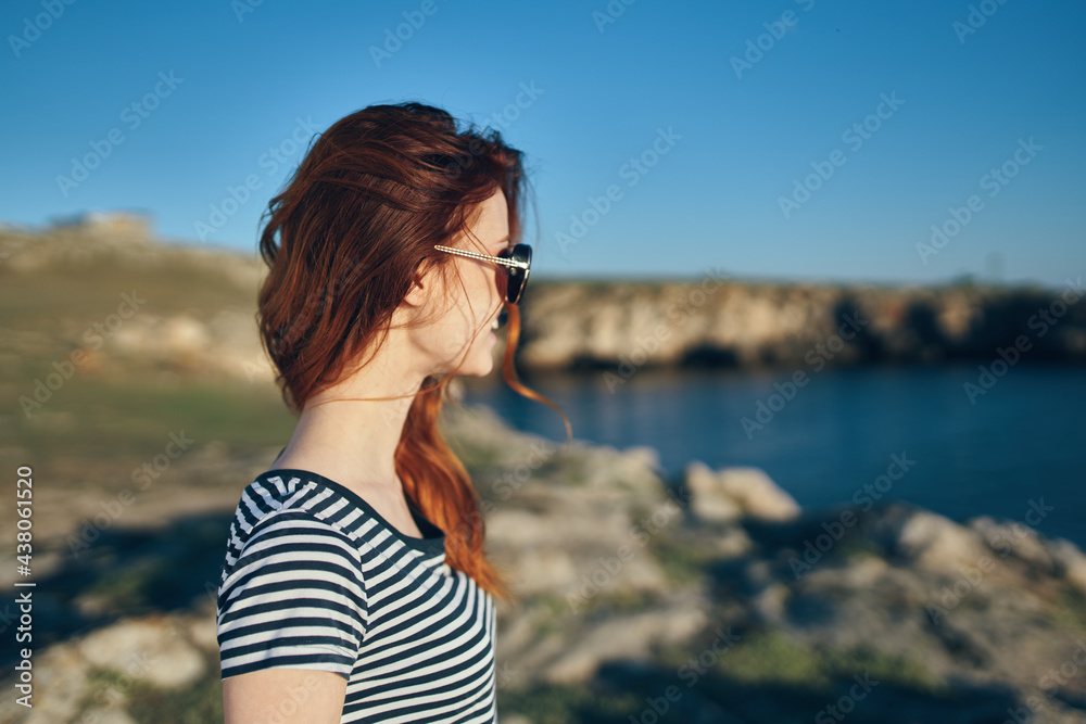 women blows near river look back and blue sky landscape side view