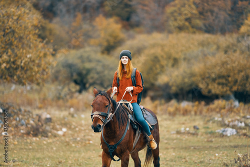 woman hiker rides a horse in a field mountains nature landscape © SHOTPRIME STUDIO